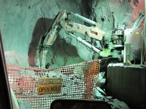 Broderson carry deck crane transporting materials inside a mining drift